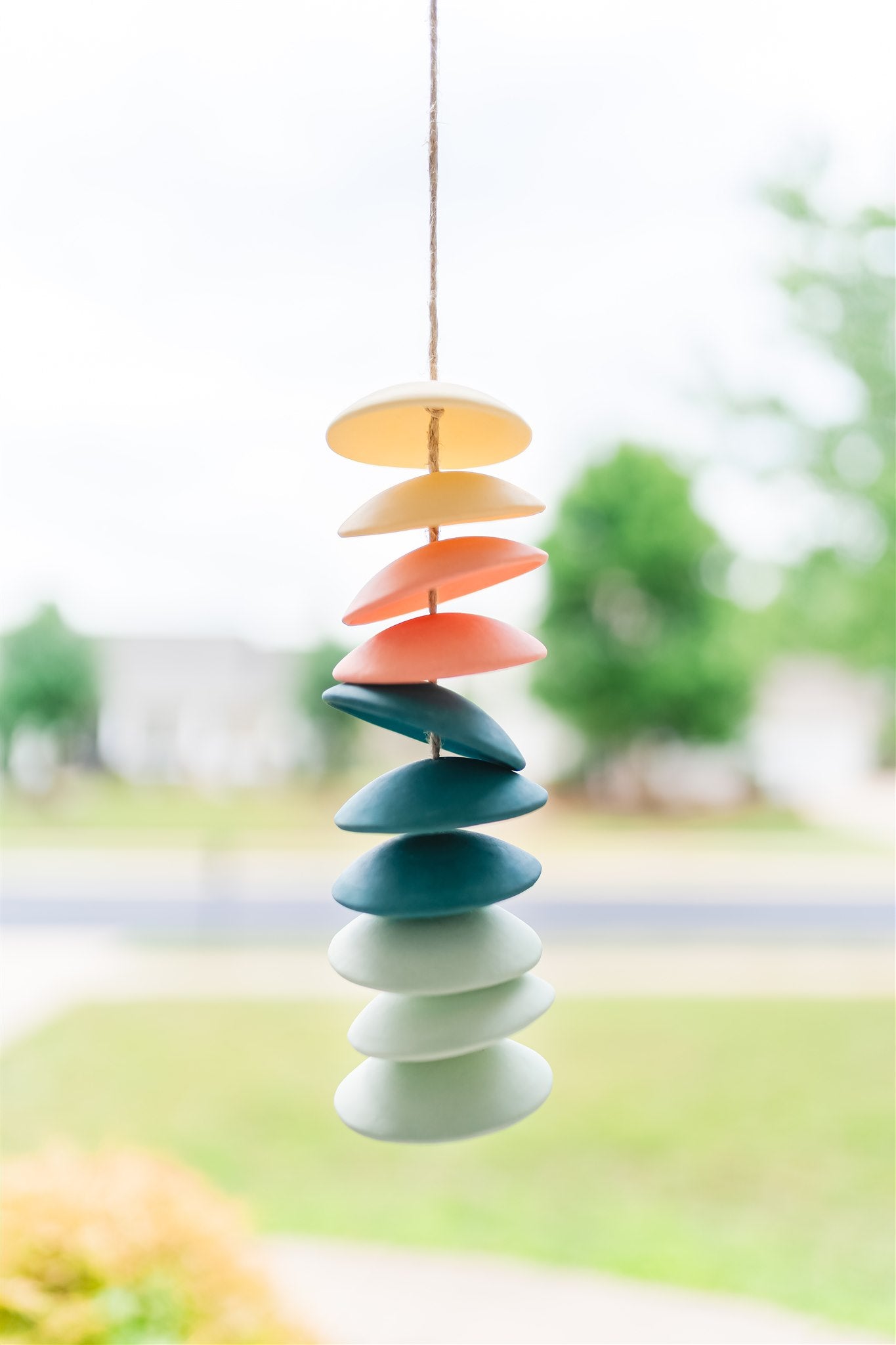 Ceramic chimes in light yellow, coral, teal, seafoam