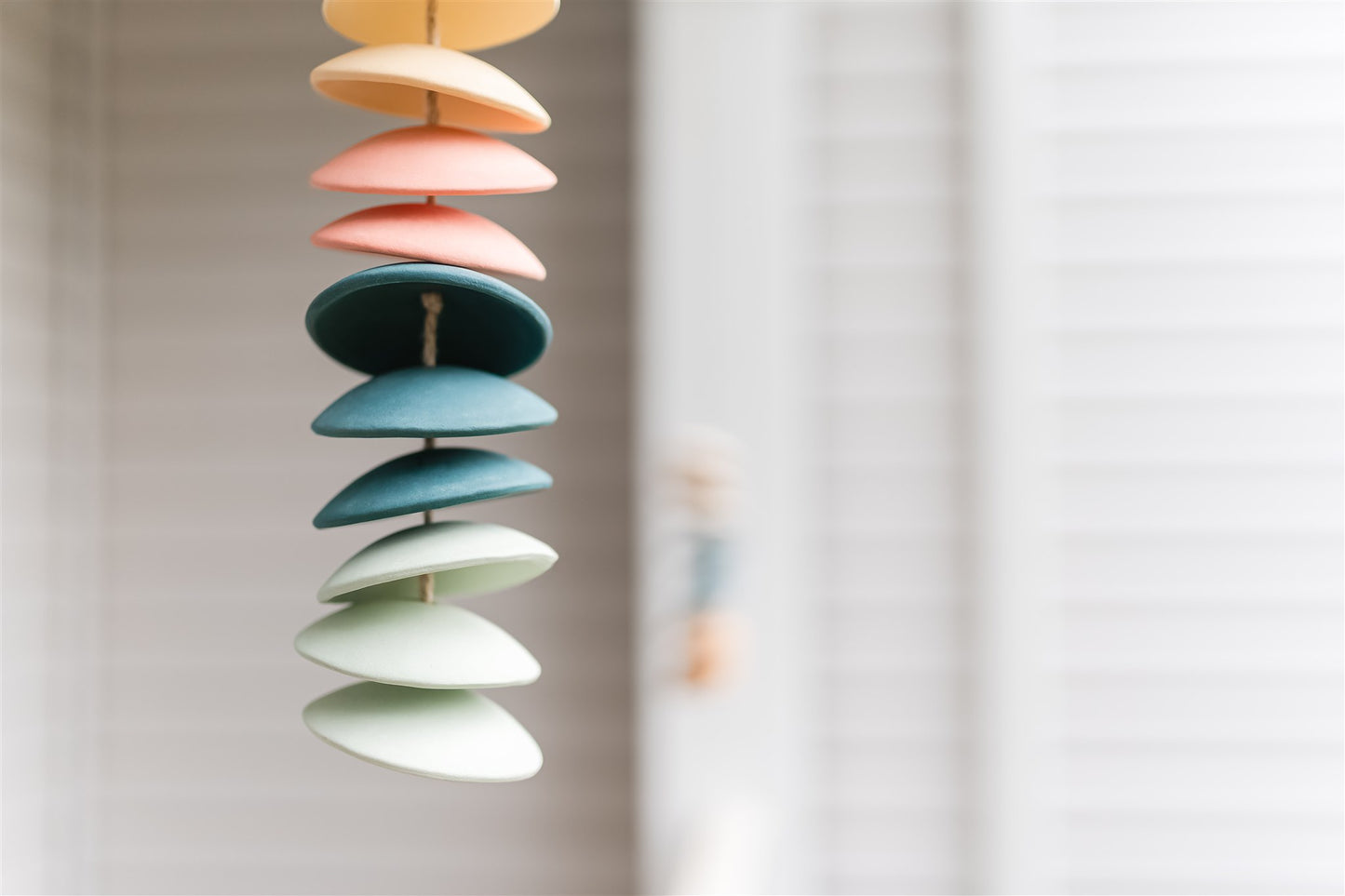 Ceramic chimes in light yellow, coral, teal, seafoam