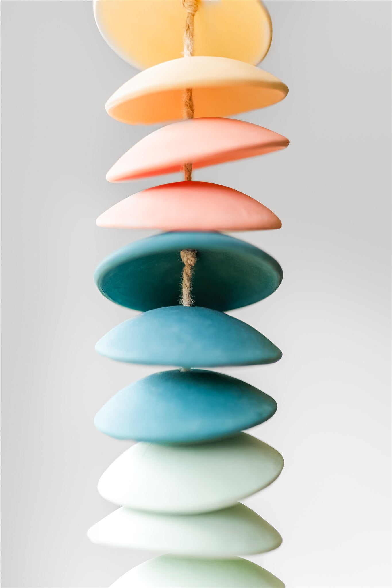 Ceramic chimes in light yellow, coral, teal, seafoam