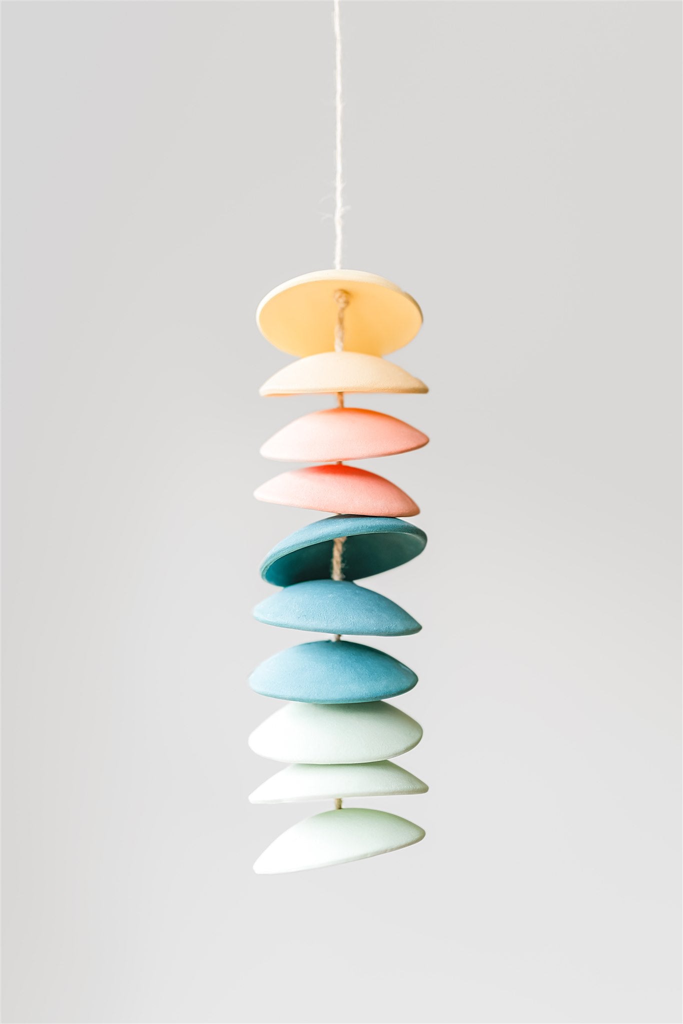 Ceramic chimes in light yellow, coral, teal, seafoam